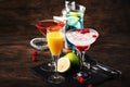 Selection of summer cocktails. Cold refreshing alcoholic beverages and drinks: mimosa, cosmopolitan, raspberry margarita and blue Royalty Free Stock Photo