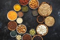 Selection of superfoods, legumes, cereals, nuts, seeds in bowls on black background. Superfood as chia, spirulina, beans, goji Royalty Free Stock Photo