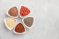 Selection of superfoods in white bowls on gray concrete background. Quinoa, chia, goji berry and flax seeds. Royalty Free Stock Photo