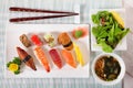 Selection of sushi plate with chopsticks on mat Royalty Free Stock Photo