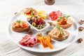 Selection of tasty bruschetta or canapes on taosted baguette and quark cheese topped with smoked salmon, shrimp.