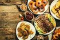 Selection of traditional hanukkah food for festive dinner, wood background