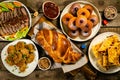 Selection of traditional hanukkah food for festive dinner, wood background