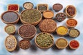 A selection of various colorful spices on a wooden table in bowls. Various kinds of spices on wooden background Royalty Free Stock Photo