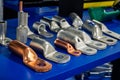 A selection of various electrical cable lugs and terminals, in copper and silver-colored metals, displayed on a blue surface. Royalty Free Stock Photo