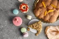 Selection of various pieces of cake - Choux pastries, macarons, chocolate velvet cake on a gray stone background.