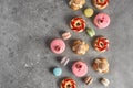 Selection of various pieces of cake - Choux pastries, macarons, chocolate velvet cake on a gray stone background.