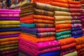 selection of vibrant sari fabrics in a market