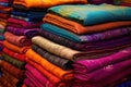 selection of vibrant sari fabrics in a market