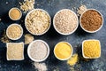 Selection of whole grains in white bowls - rice, oats, buckwheat, bulgur, porridge, barley, quinoa, amaranth Royalty Free Stock Photo