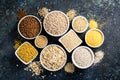 Selection of whole grains in white bowls - rice, oats, buckwheat, bulgur, porridge, barley, quinoa, amaranth Royalty Free Stock Photo