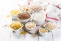 Selection of whole grains in white bowls - rice, oats, buckwheat, bulgur, porridge, barley, quinoa, amaranth, Royalty Free Stock Photo