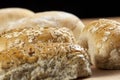 Selection of wholegrain seeded bread rolls on a breadboard Royalty Free Stock Photo