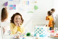 Selective focus of adorable kid sitting at table with cake and looking at camera during birthday party. Royalty Free Stock Photo