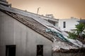 Selective blur on an abandoned building, damaged, with a roof made of asbestos tiles, toxic, some of the roofing