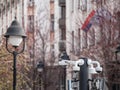 Selective blur on dome cctv cameras seen from afar in front of an old street in an urban European city center downtown. These CCTV Royalty Free Stock Photo