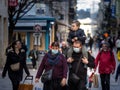 Selective blur on a European Family, a father and mother, and their son, a toddler walking wearing face mask protective equipement