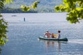 Selective blur on a family, father, mother, daughter, paddling on a canoe, canoeing, on lake Bohinj, a major tourist destination Royalty Free Stock Photo