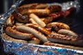 Selective blur on grilled bratwurst, white sausages, hot, ready to be served as street food. Bratwurst is a typical german white