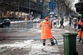 Selective blur on a man, a city worker from belgrade with fluo ppe equipment removing snow with a snow showel