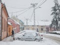 Selective blur on a man removing snow with a snow showel in the city of pancevo in a cold winter, during a snowsorm in december