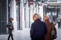 Selective blur on an old couple, senior man and woman, married, walking, observing a younger kid