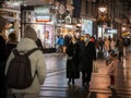 Selective blur on Old senior man and woman, couple, wearing a facemask, waking in street of Belgrade in winter at night on covid Royalty Free Stock Photo