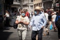 Selective blur on Old senior man and woman, couple, wearing a facemask, waking  in street of Ljubljana during coronavirus covid 19 Royalty Free Stock Photo