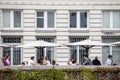 Selective blur on a packed patio of a cafe restaurant with people sitting, not respecting social distancing, in the city center Royalty Free Stock Photo