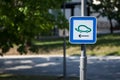 Selective blur on a road sign indicating an electric car charging station used to fill with electricity electrical vehicles