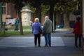 Selective blur on a senior couple, man and woman, walking in the streets of Szeged, Hungary
