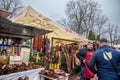 Selective blur on serbian butcher discussing with clients on a Stand in the Slaninijada Kacarevo market selling cured meat,sausage