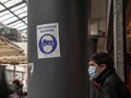 Selective blur on a sign indicating that face mask is mandatory in French, in Bordeaux Capucins market,