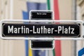 Selective blur on a street sign indicating Martin Luther Platz square, one of the main squares of Dusseldorf city center in