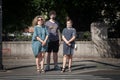 Selective blur on three young persons, two girls and a boy, friends, some wearing a respiratory face mask in streets of Belgrade Royalty Free Stock Photo