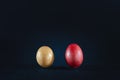 Selective blur on two eggs, one brown egg, one dyed in red, according to the Serbian Easter tradition, isolated on a black Royalty Free Stock Photo