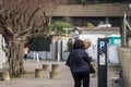 Selective blur on two senior persons, confused, trying to understand technology and to pay for their car at a parking meter Royalty Free Stock Photo