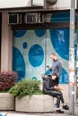 Selective blur on two young persons, man and woman watching their smartphones and looking at its content