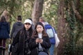 Selective blur on Two young women, Asians, from Japan, tourists in Arcachon, France using their smartphones and applications