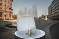 Selective blur on the water flowing from a public drinking fountain in a park, aimed at people accessing and drinking fresh and