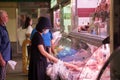 Selective blur on a woman looking at food to buy in Dolac Trnica maket in zagreb wearing face mask respiration equipment