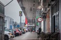 Selective blur on a woman wearing a facemask using her phone in a closed mall in pancevo due to lockdown and shorted working hours