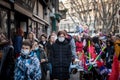 Selective blur on a Woman, young, walking in a crowd wearing face mask respiration protective equipement on Coronavirus Covid 19