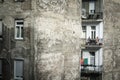 Selective blur on a young couple, lovers, on a balcony during a warm summer afternoon in a decayed and neglected residential build