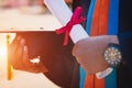 Selective and close-up focus of a university graduate holds a degree certificate and graduation cap celebrates in the graduation c Royalty Free Stock Photo