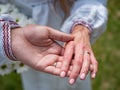 Selective closeup shot of a Caucasian couple wearing rings holding hands Royalty Free Stock Photo