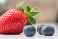 Selective closeup shot of ripe strawberry and blueberries Royalty Free Stock Photo