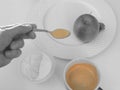 Hand with spoon tasting coffee