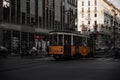 Selective color shot of a tram driving on the streets of Milan in Italy