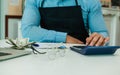 Selective focus on accounting man hand using calculator, calculating income, budget, profit with dollar bank notes after selling Royalty Free Stock Photo